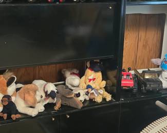 Large Black Entertainment Unit; Kids Toy Trucks and Cars, including stuffed animals