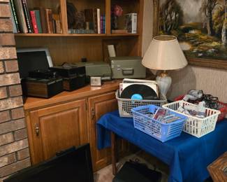 Books; Book Sets and Collections; Bell & Howell Cube Slide Projector; TVs; LPs, CDs, Sega Games and Equipment; Painting; Lamp; and two GE Table Stereo Turntables