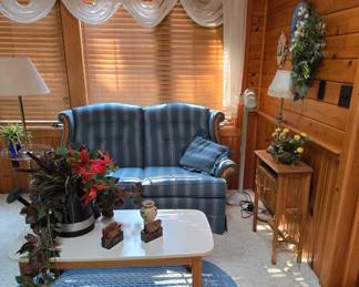 Blue Striped Loveseat; Blue Braided Area Rug; Coffee Table; Silk Floral; Lamps and Small Console Table for storage