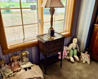 Doll Collection; Small Side Table with Metal Fret work and 3 Drawers; Table Lamp; Wood Rocker; Fleece Blanket