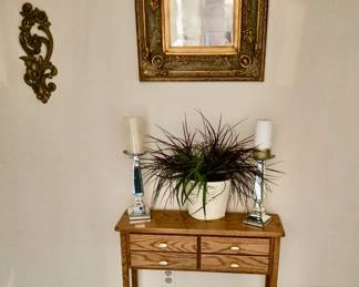 Another pretty oak wood small console table; Candles and Candle Sticks; Decorative Mirror; and a silk plant