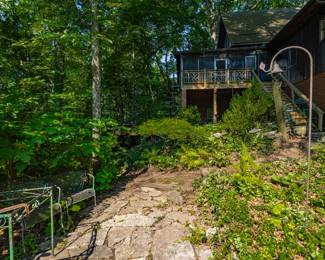 Breathtaking gardens, screened porch and so much more.