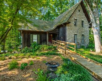 Nestled on a sprawling 4-acre lot with river frontage, this enchanting two-story home is straight out of an English Storybook. Lots of charm and character throughout. A Must See!
