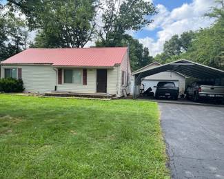 This home has vinyl siding, metal roof, replacement windows, and two car garage, paved drive, deck, storage building, and more on a large lot backing up to a farm.