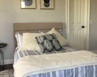 Bed, bedding, rug, and pictures