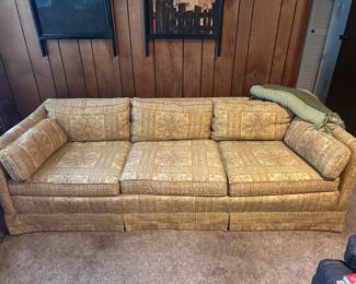 Long low gold vintage sofa