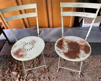 pair of metal chairs with matching table