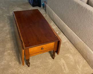 Low drop leaf table. 38" x21", with open leaves 42" wide. $150