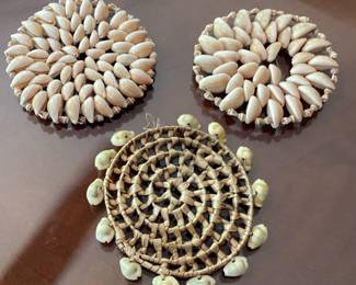 Hand woven coasterd and a storage basket decorated with seashells
