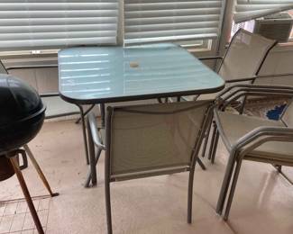 Outdoor Glass Top Table With Matching Chairs And Charcoal Grill