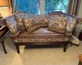 Jungle print motif loveseat with rolled arms and pillows