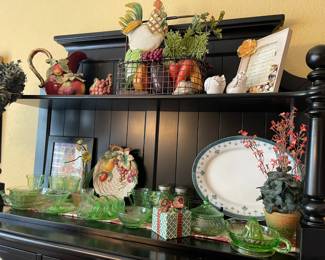 A close look at the top of the hutch, lots of great pottery, depression glass, Fitz and Floyd pieces