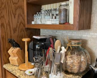 Lots of glass spice storage jars, vintage coffee storage jars, Ninja, Knives, and lots of utensils