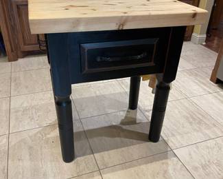 A close look at the butcher block/island with drawer and hooks