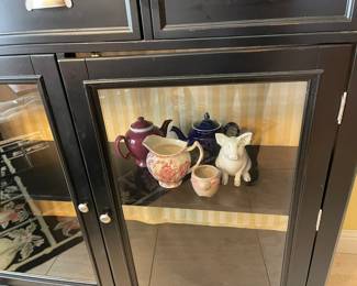 The lower cupboard of the hutch, Hall tea pot, transfer ware jug and ceramic pigs!