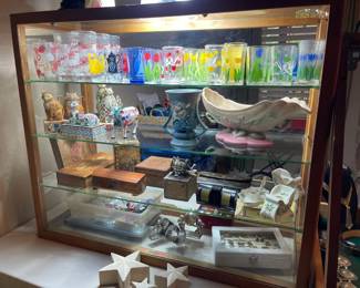 In this large showcase you will find, vintage Swanky Swig glasses, vintage Oklahoma University National Champion glasses, Roseville, Hull, Jim Shore Cats, vintage boxes, Lenox Christmas china, vintage fishing reel