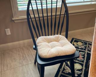 One of the four dining chairs all have seat cushions