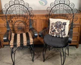 Pair of Black Wrought Iron Chairs with Decorative Scrollwork and Cushions