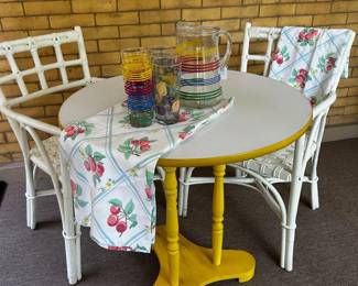 Painted rattan chairs and vintage table