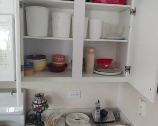 kitchen storage, cups glasses, platter, small stained glass lamp