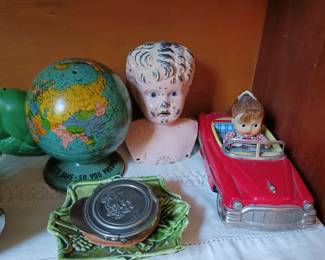 Japan tin litho friction toy car featuring "Little Suzy" in a red convertible. $50. Minerva German tin metal doll head $20. vintage Ohio Art tin litho world globe piggy bank $10