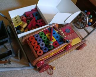 Playskool wooden pull toy wagon filled with wooden blocks and rods.  $20