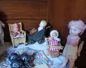 antique sterling silver baby rattle with a whistle and bells.  $35.  antique all-bisque doll ?? check face. antique doll carriage or pram, possibly made of metal or cast iron.  Kilgore $15