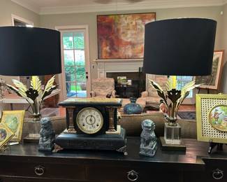 Heavy marble clock, stone foo dogs, and metal and lucite lamps.