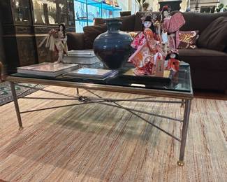 Metal coffee table with thick, heavy, beveled glass top.