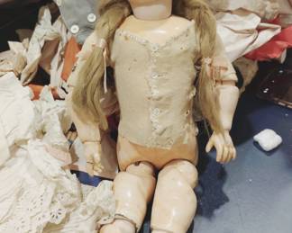 Very old bisque porcelain doll with original clothing from England