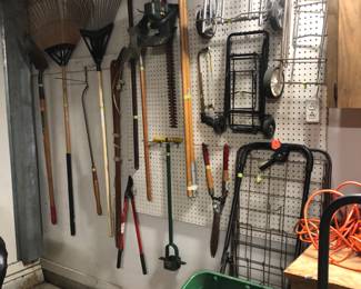 Garage gardening tools, shopping g carts, spreader, extension cords.