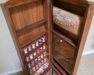 Antique sewing cabinet with notions