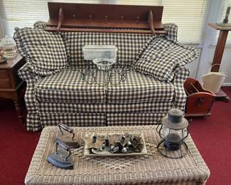 Little loveseat, wicker coffee table, antique irons