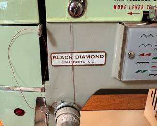 #116 - $280 - Black sewing cabinet with Singer sewing machine