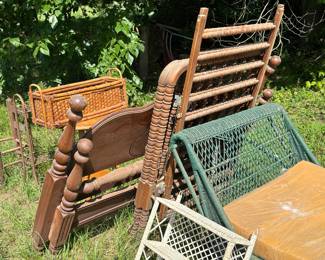 Come stroll through our vintage to antique furniture gallery. Here’s a vintage Jenny Lind crib with some wicker pieces, a giant rattan daybed and a metal plant stand