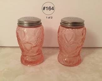 Set of pink depression glass shakers in strawberry pattern