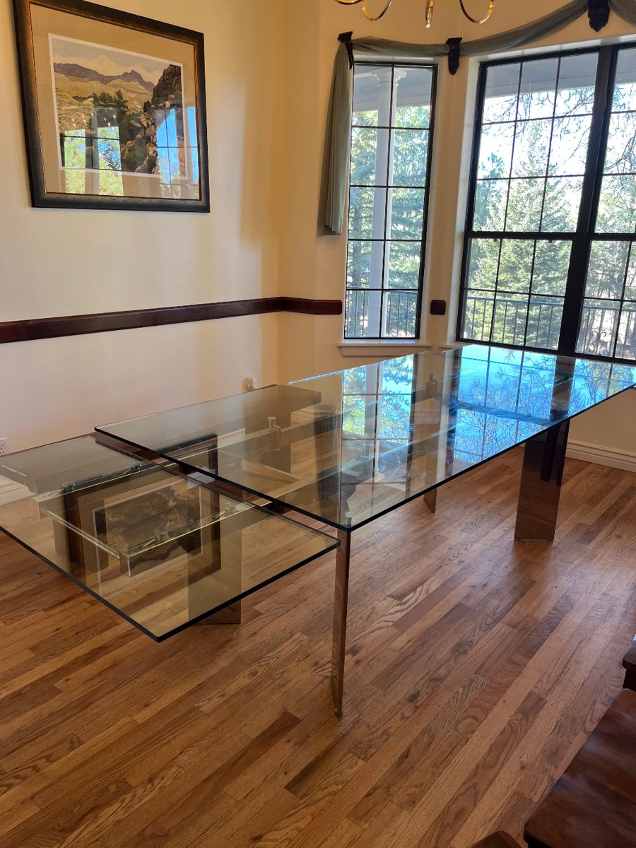 Glass dining room table 108 inches expands to 120 inches.
