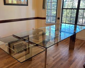 Glass dining room table 108 inches expands to 120 inches.