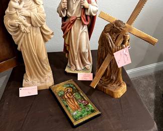 Finely detailed carved sculptures of Madonna and Child, Christ the Good Shepherd, and Jesus Carrying the Cross.
