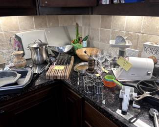 Many Kitchen accessories and cookware.