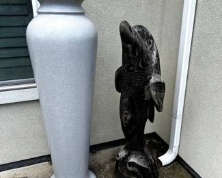 Stone Dolphin and outdoor pottery.
