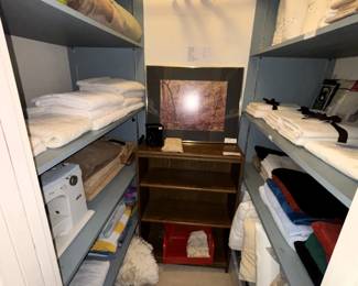 Linens, sewing machine, three shelf cabinet, towels.