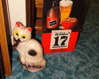 Black Label calendar, and cast iron kitten door stop