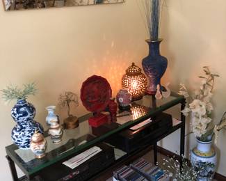 Lincoln, glass consul table, Kenwood, CD player, five disc, technics stereo system, and two speakers. CDs , ornate mirror, Lots of Asian home decor.