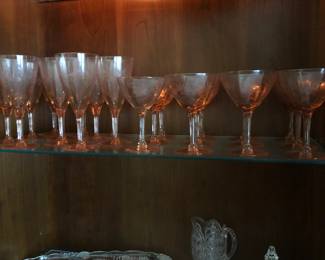 Pink depression, glass, water goblets, and champagnes, other cut glass, crystal, Lenox, champagne, glasses, and much more in the China hutch.