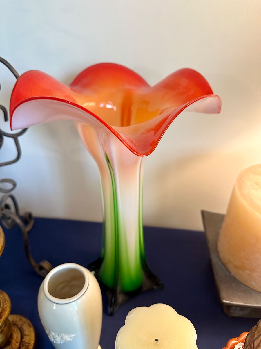 Hand-blown art glass lily-shaped vase with vibrant orange and pink hues; elegant statement piece for any decor.