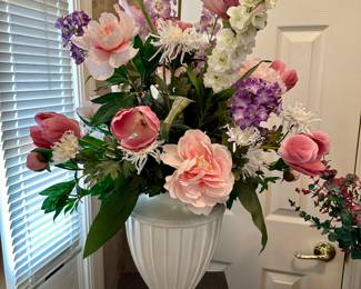 Large floral arrangement in white urn