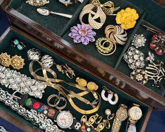 Tray of assorted vintage costume jewelry featuring earrings, brooches, bracelets and pins; perfect for collectors and crafters.