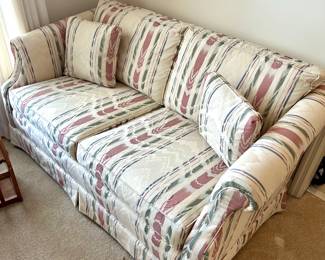 Striped upholstered sofa with matching pillows