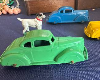 Group of vintage plastic toy cars and dog figurine